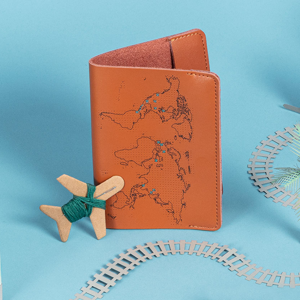 image of the brown cognac genuine leather passport cover with green stitches over countries that have been visited traveled to