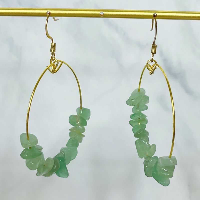 Green beaded hoop earrings close up