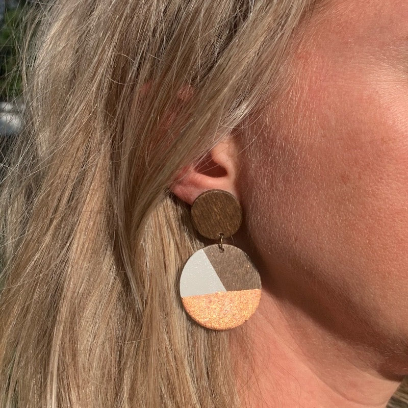 Hand painted rose gold wood earrings on model