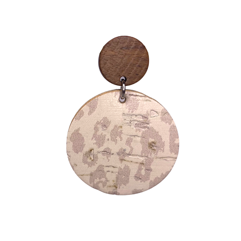 neutral cream leopard print drop earrings on cork faux leather and wood close up