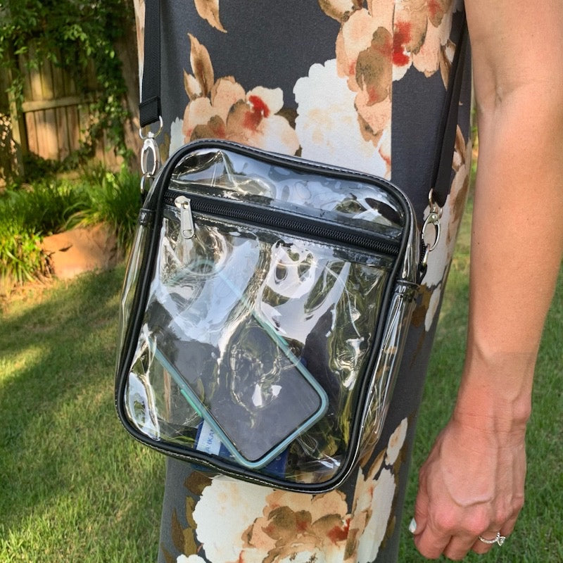 Bring your essentials with you while keeping them safe and secure with this clear crossbody stadium purse! This bag has a front zipper pocket and a spacious interior, perfect for all your needs while you're at the game or out and about. With a zipper closure, you'll have peace of mind knowing your belongings are safe and sound.