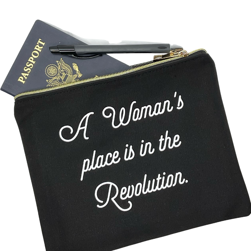 a woman's place is in the revolution black and white zipper pouch with passport and pen makes a great makeup bag or organization for carry on purse and travel feminism women empowerment