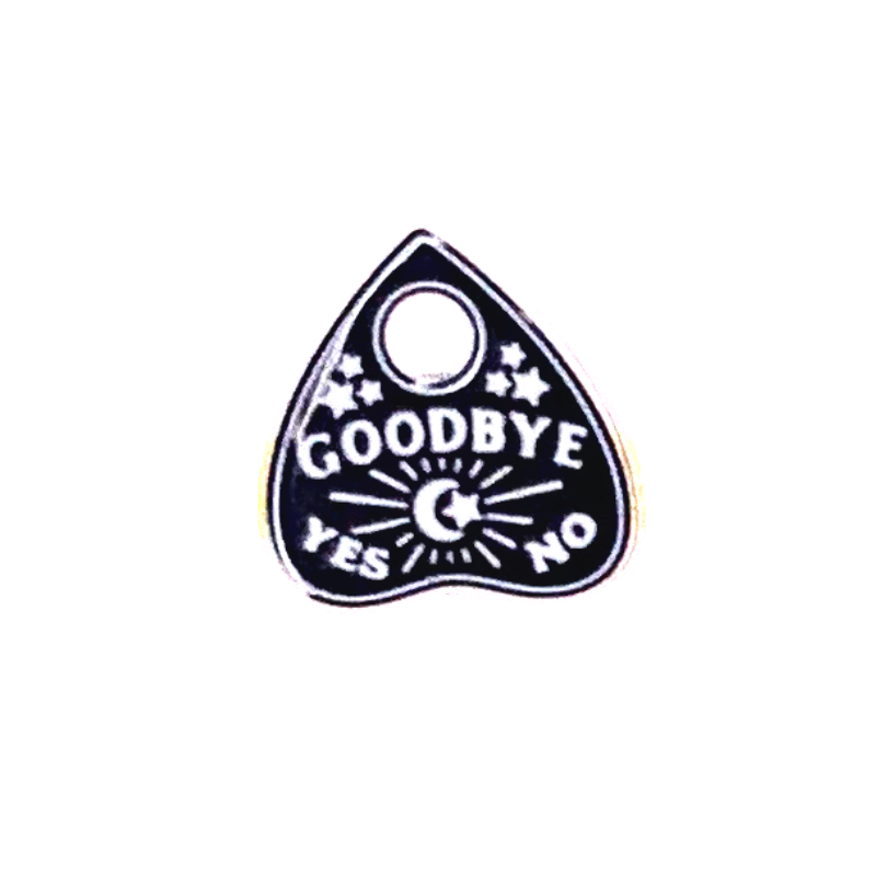 ouija board planchette stud earring close up the planchette is black and white and says goodbye and has yes no at the bottom