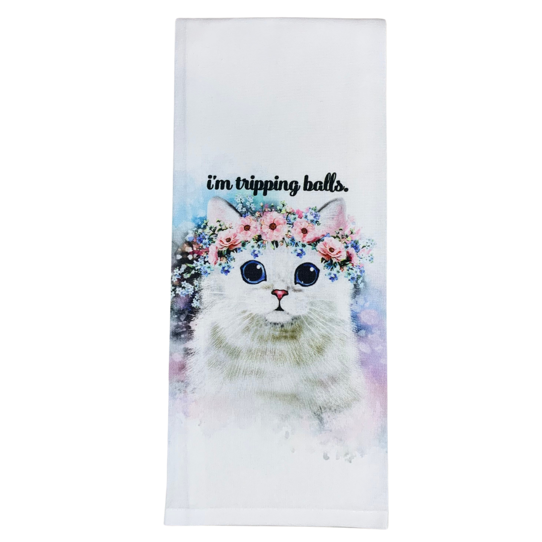 premium quality pre-shrunk hand kitchen towel that is white and says i'm tripping balls with an image of a white cat with wide eyes wearing a beautiful flower crown