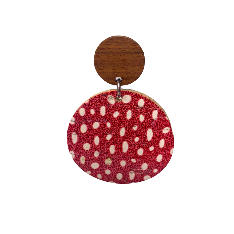 red and white polka dot pattern earrings on cork faux leather and wood close up